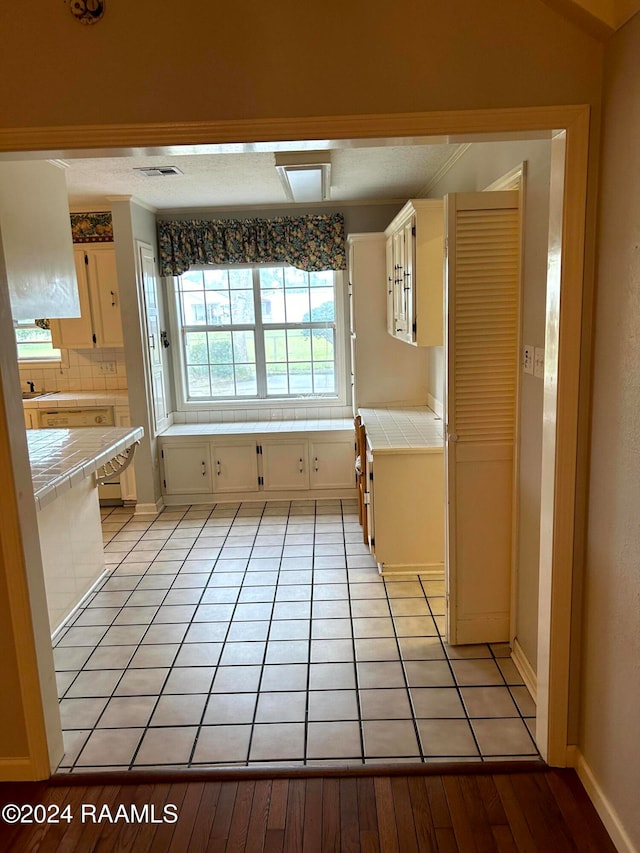 bathroom with tasteful backsplash and hardwood / wood-style flooring