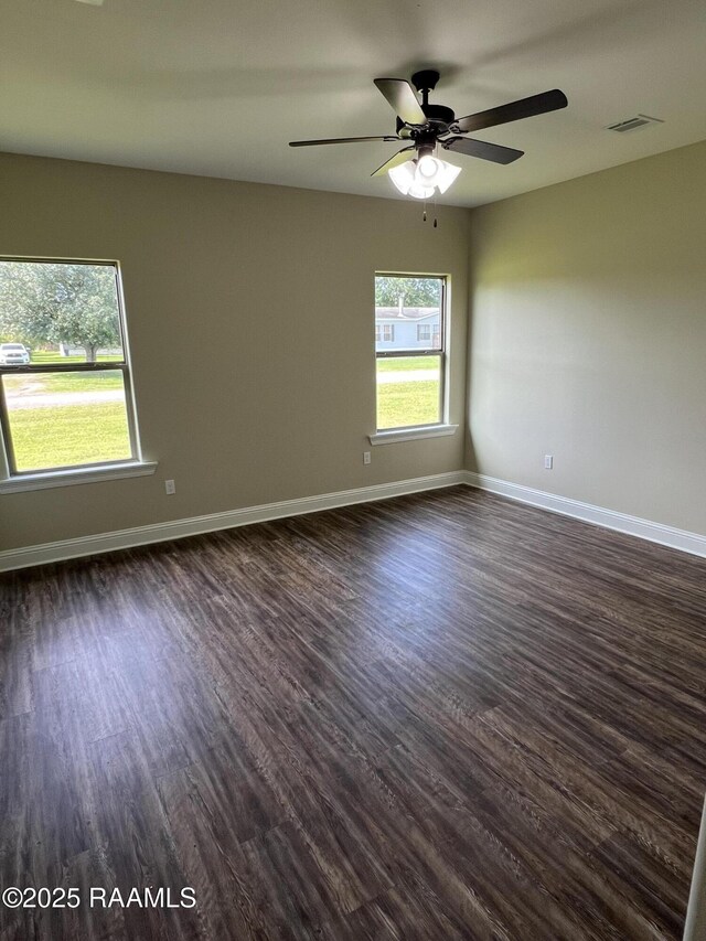 284 Sugarland Cir, Opelousas, LA 70570 - spare room featuring dark wood-style floors, ceiling fan, and baseboards