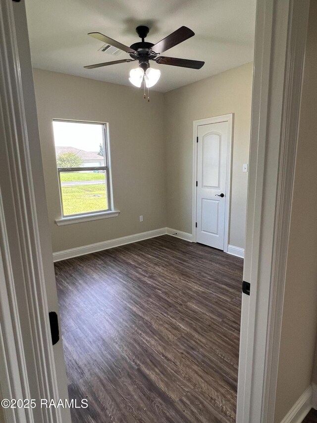 284 Sugarland Cir, Opelousas, LA 70570 - empty room with a ceiling fan, dark wood finished floors, and baseboards