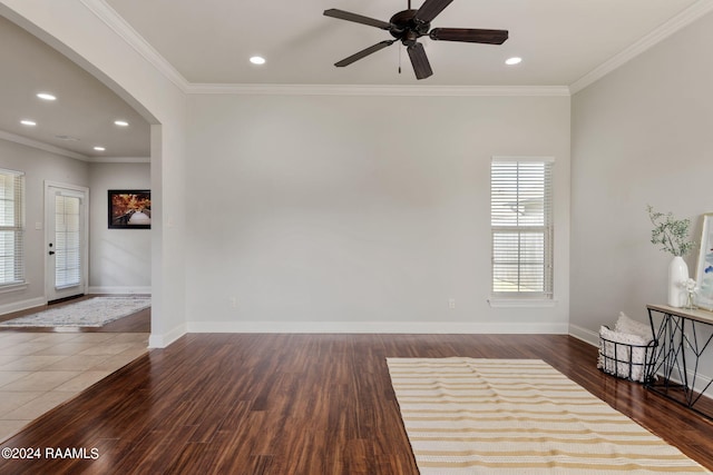 interior space with dark hardwood / wood-style flooring, ornamental molding, and ceiling fan