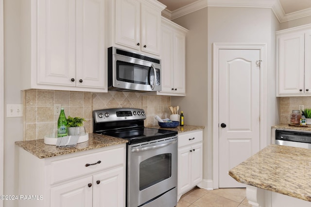 kitchen featuring light tile patterned floors, crown molding, stainless steel appliances, and white cabinets