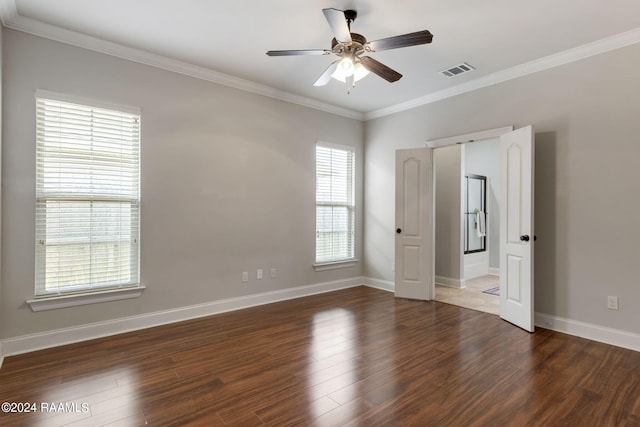 empty room featuring dark wood-type flooring, ceiling fan, and ornamental molding