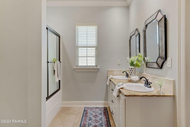 bathroom featuring crown molding, enclosed tub / shower combo, vanity, and tile patterned flooring