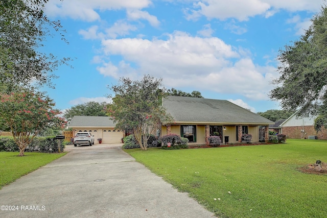 ranch-style house featuring a garage and a front lawn