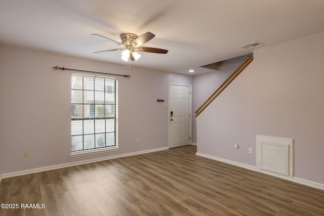 unfurnished room with dark hardwood / wood-style flooring and ceiling fan