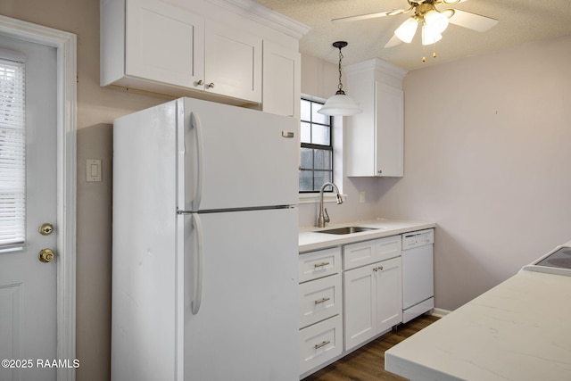 kitchen featuring ceiling fan, sink, hanging light fixtures, white appliances, and white cabinets