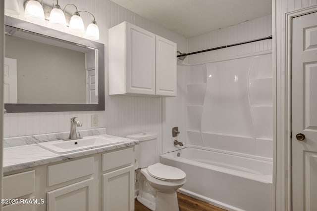 full bathroom with toilet, hardwood / wood-style floors, vanity, and bathing tub / shower combination