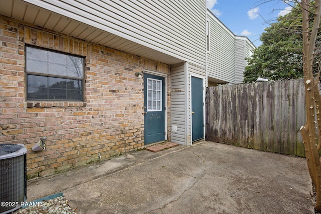 property entrance with central AC unit and a patio area