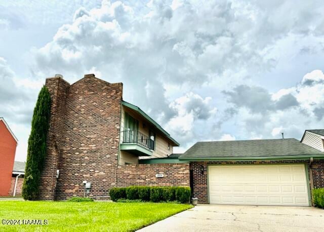 view of front of property featuring a balcony and a garage