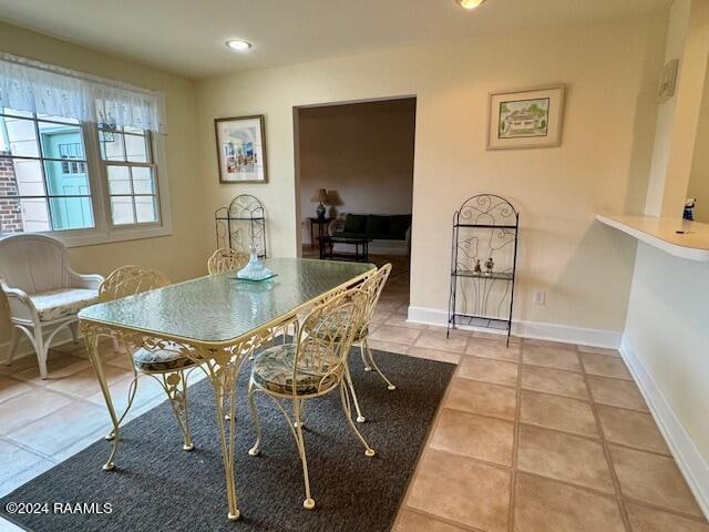 dining space featuring light tile patterned floors