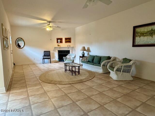 living room featuring light tile patterned flooring and ceiling fan