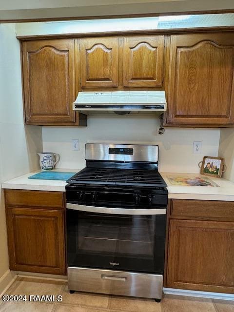 kitchen featuring light tile patterned flooring and stainless steel range with gas stovetop