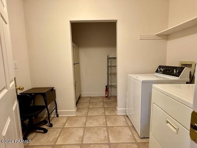 washroom with light tile patterned floors and washing machine and clothes dryer