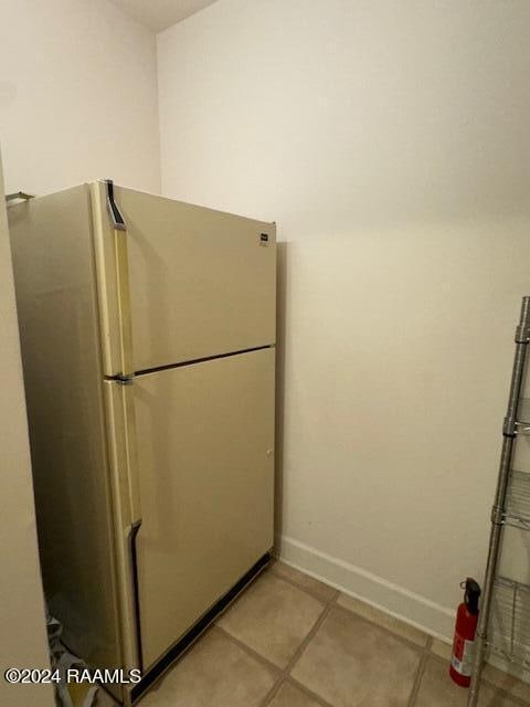 kitchen featuring white refrigerator and light tile patterned floors