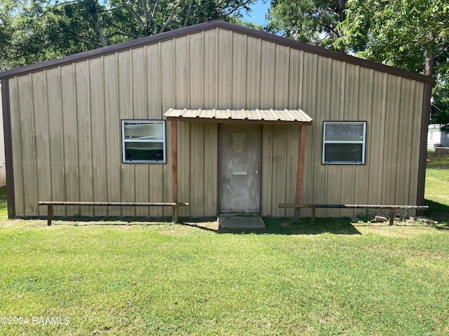 view of outbuilding featuring a lawn