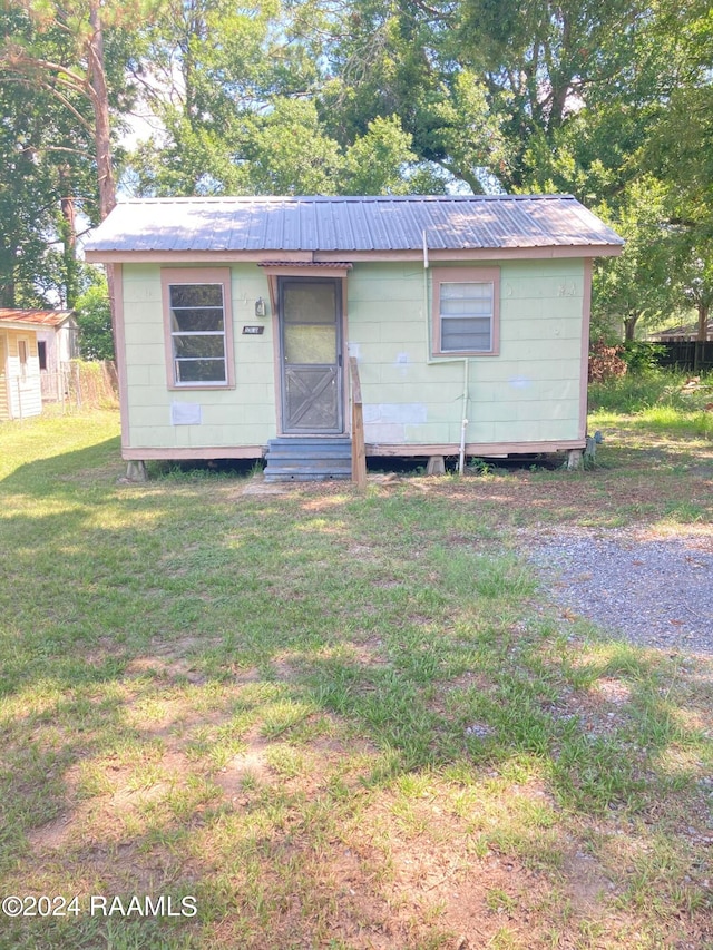 view of front of property with a front lawn and an outdoor structure