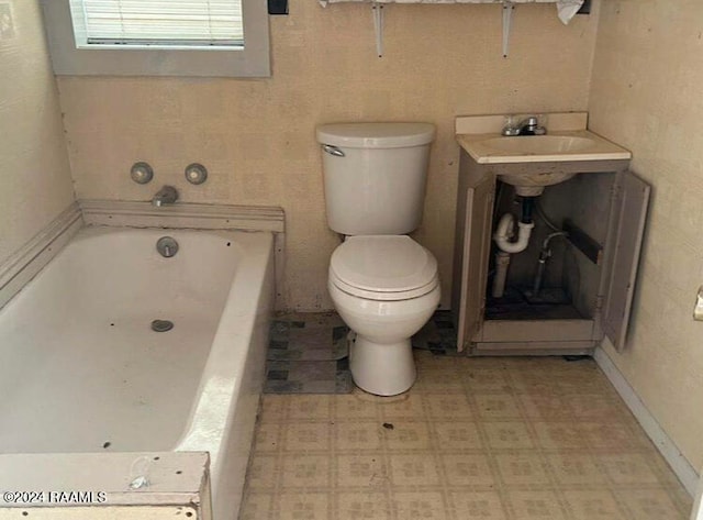 bathroom featuring tile patterned floors, a bathtub, and toilet