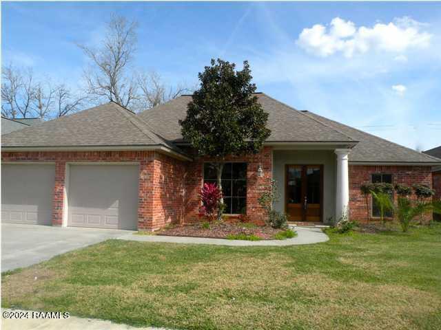 view of front of property with a garage and a front yard