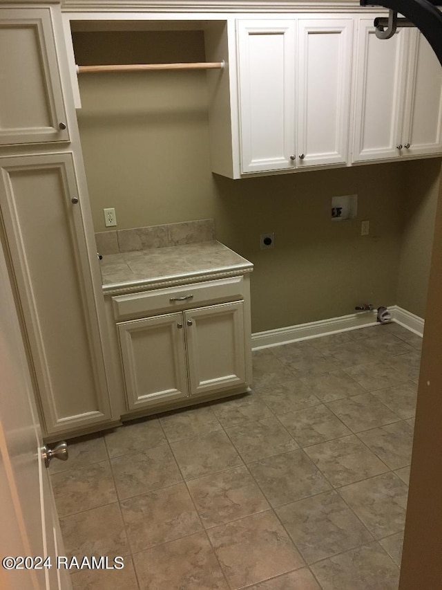 laundry area featuring cabinets, washer hookup, hookup for a gas dryer, and electric dryer hookup