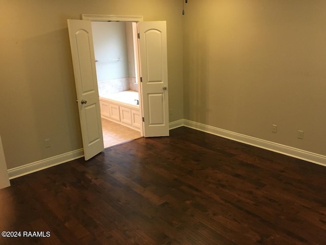 unfurnished bedroom featuring dark wood-type flooring