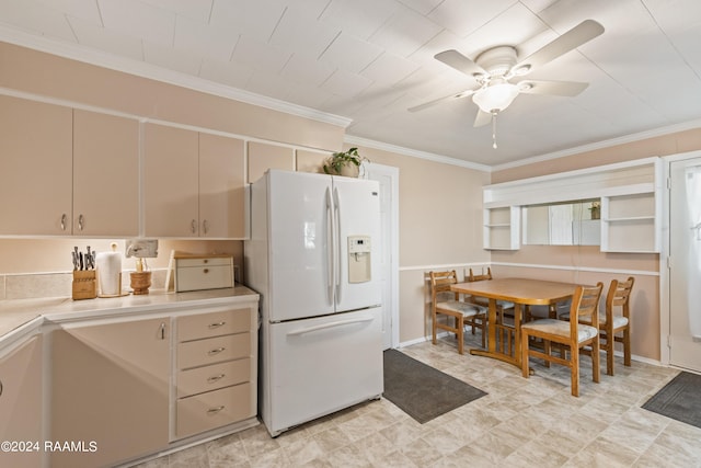 kitchen with white fridge with ice dispenser, light tile patterned floors, cream cabinetry, ceiling fan, and ornamental molding