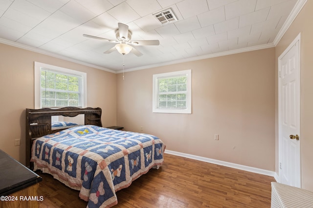 bedroom with crown molding, multiple windows, ceiling fan, and hardwood / wood-style floors