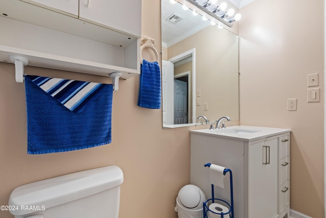 bathroom featuring vanity, ornamental molding, and toilet