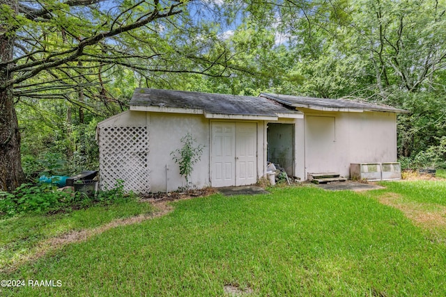 rear view of property featuring a yard