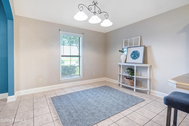 living area featuring a notable chandelier and light tile patterned flooring