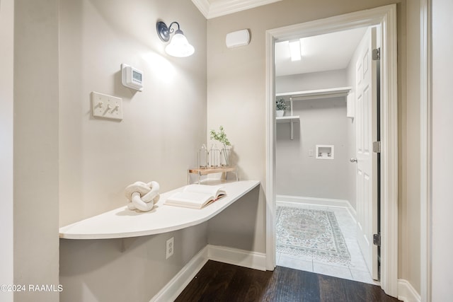 bathroom with wood-type flooring and ornamental molding