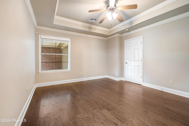 empty room featuring ceiling fan, hardwood / wood-style flooring, a raised ceiling, and ornamental molding