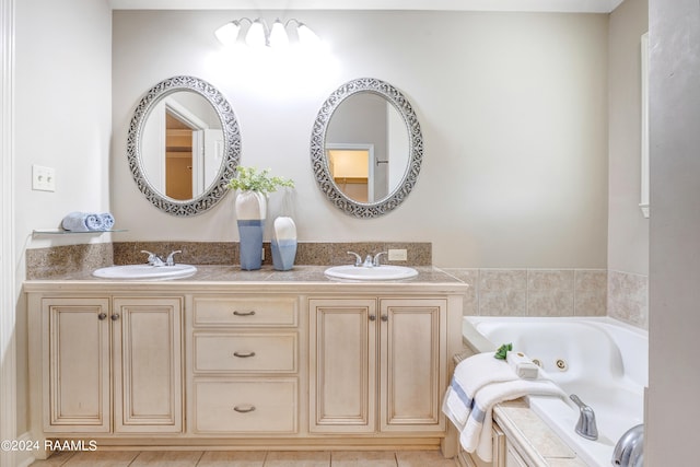 bathroom with tile patterned flooring, a washtub, and double sink vanity