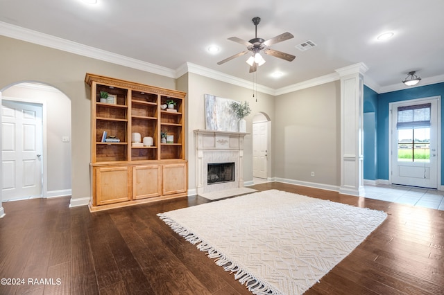 unfurnished living room with ornamental molding, a fireplace, ceiling fan, and hardwood / wood-style floors