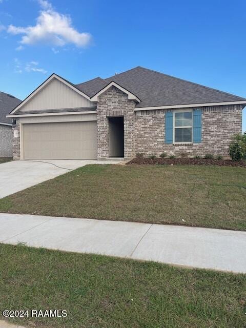 ranch-style home with a garage, a front lawn, concrete driveway, and brick siding