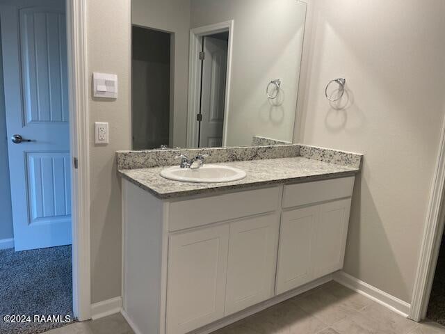 bathroom with vanity and baseboards