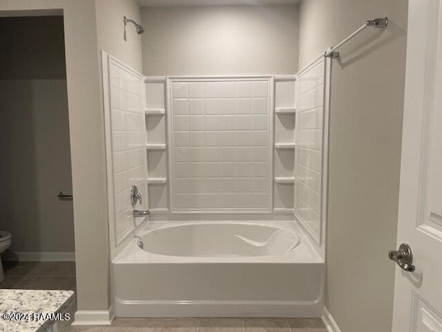 full bathroom featuring toilet, tile patterned flooring, baseboards, and shower / bathing tub combination