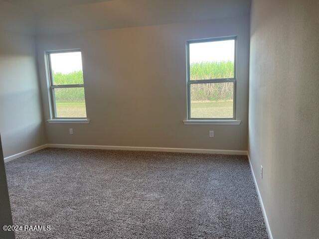 spare room with carpet floors and baseboards