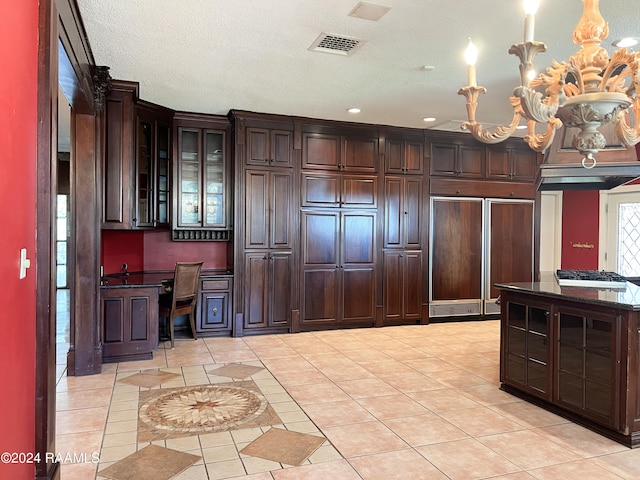 kitchen with hanging light fixtures, light tile patterned flooring, an inviting chandelier, and dark brown cabinetry