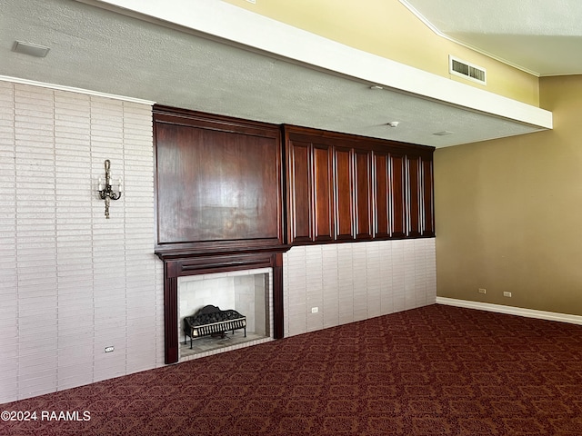 unfurnished living room featuring carpet floors and a textured ceiling