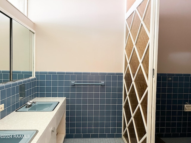 bathroom featuring tile walls, tile patterned flooring, and vanity