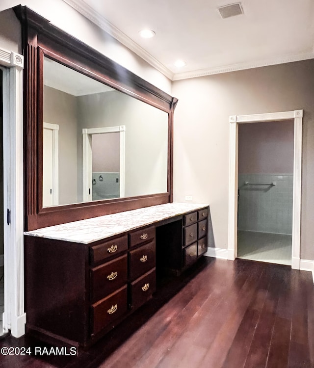 bathroom with hardwood / wood-style floors, vanity, and tiled shower