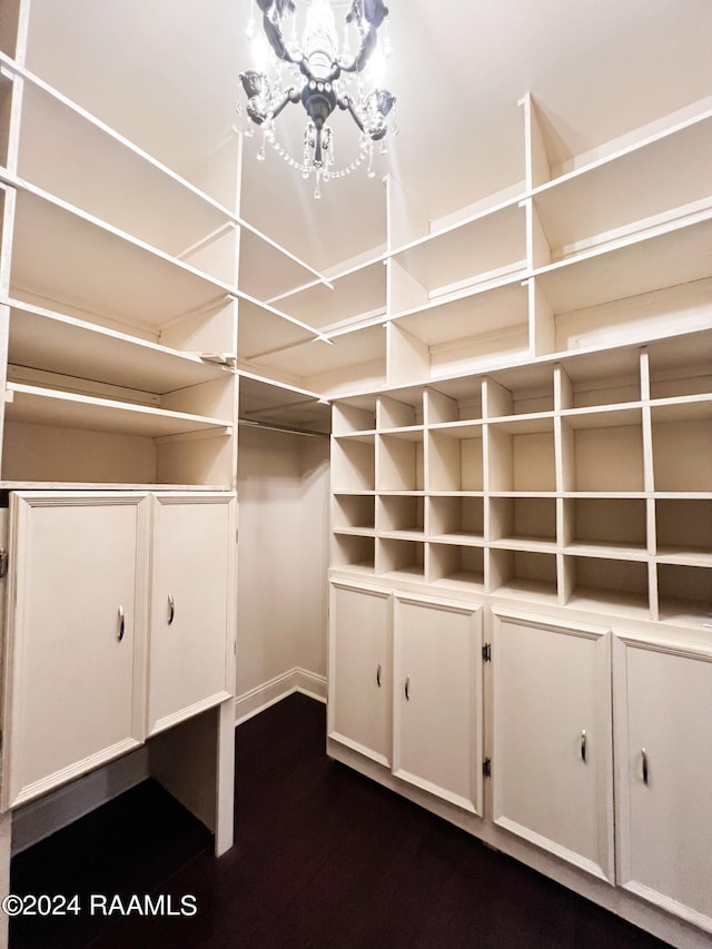 walk in closet featuring an inviting chandelier