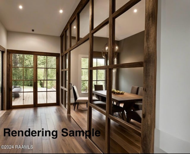 dining area featuring french doors, hardwood / wood-style floors, and a high ceiling