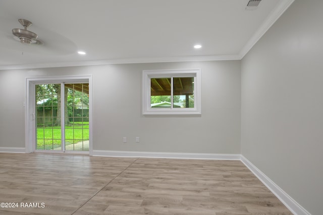 spare room with a healthy amount of sunlight, light wood-type flooring, and ceiling fan