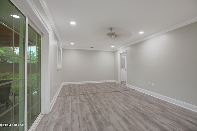 spare room with ceiling fan, light wood-type flooring, and crown molding