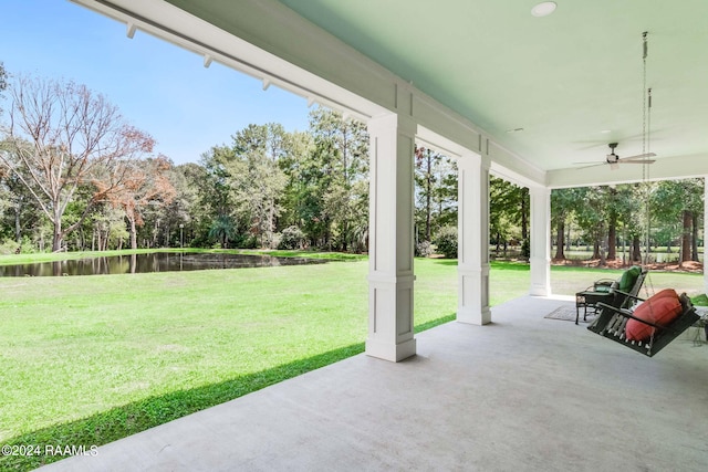 view of patio featuring a water view and ceiling fan