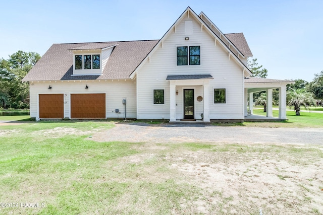 modern farmhouse with a front lawn, dirt driveway, and roof with shingles