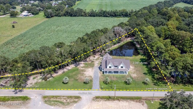 birds eye view of property featuring a water view and a rural view