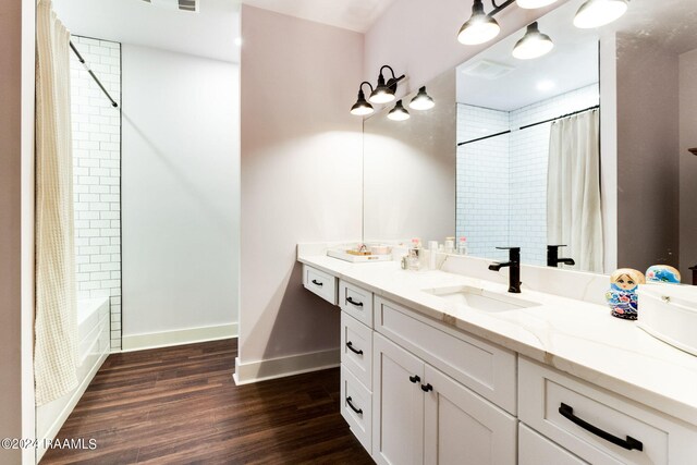 bathroom with shower / tub combo, vanity, and hardwood / wood-style flooring