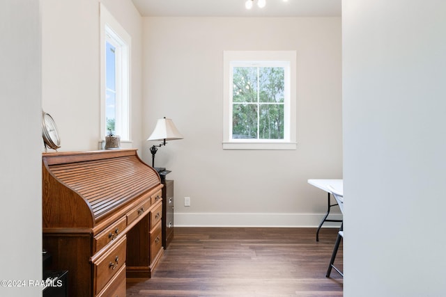 miscellaneous room with baseboards and dark wood-style flooring